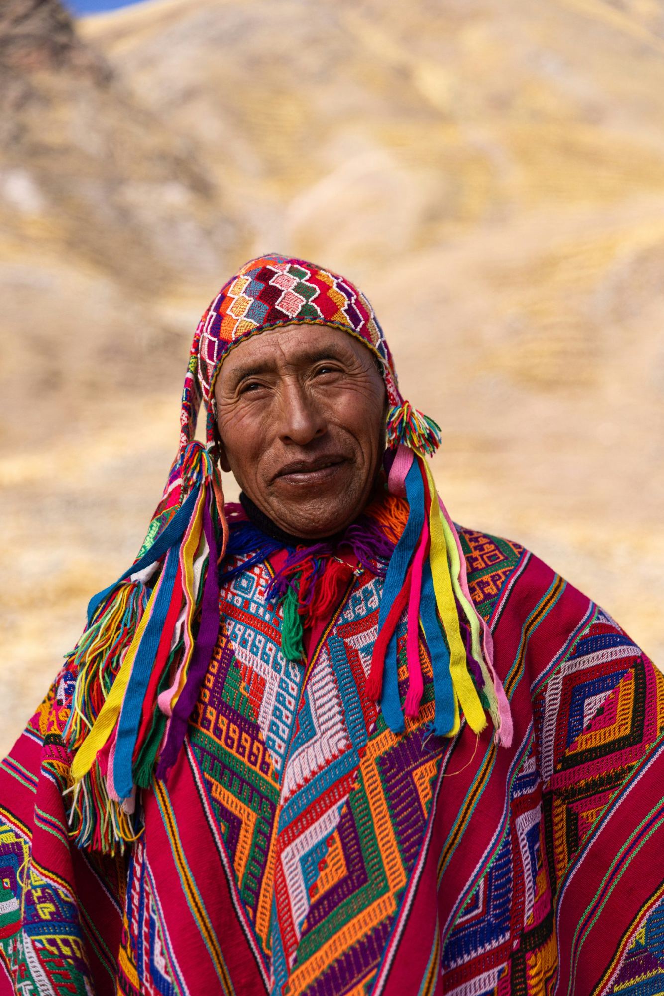 An Andean elder in a woven chullo and poncho