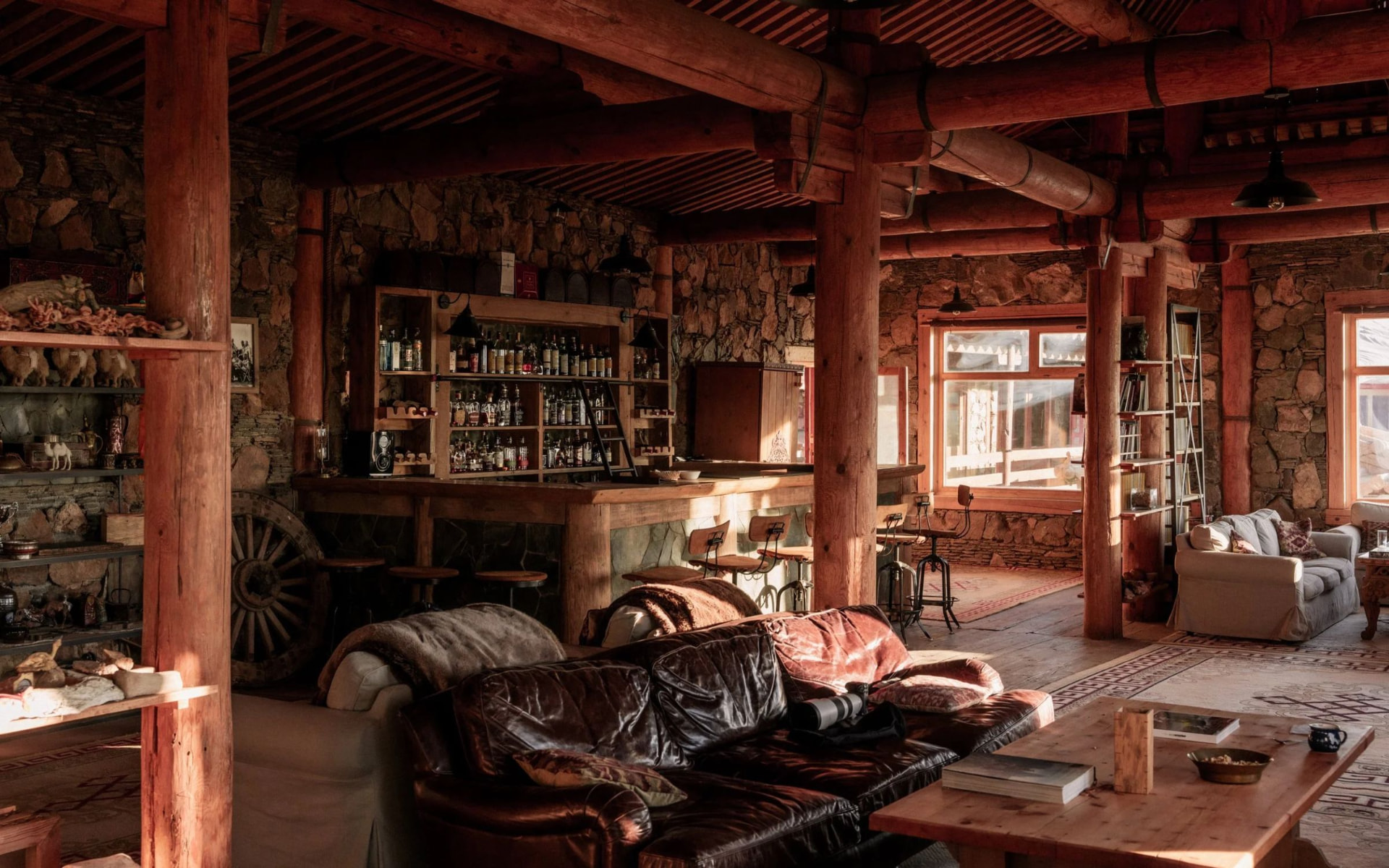 The lodge interior with leather sofas and timber beams