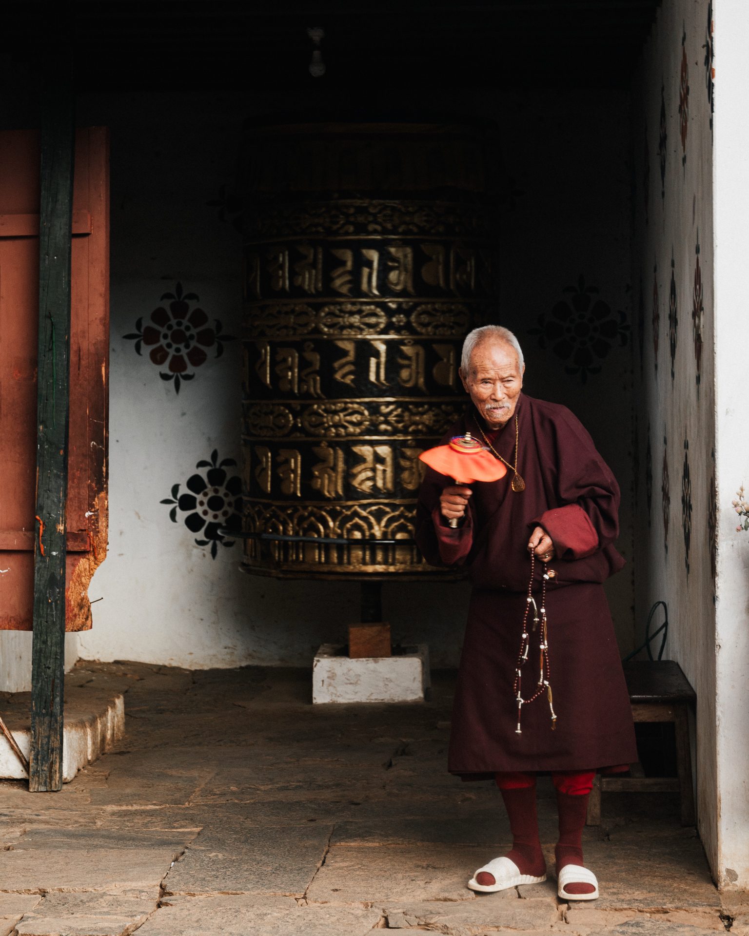 An elder turning a prayer wheel in Bhutan