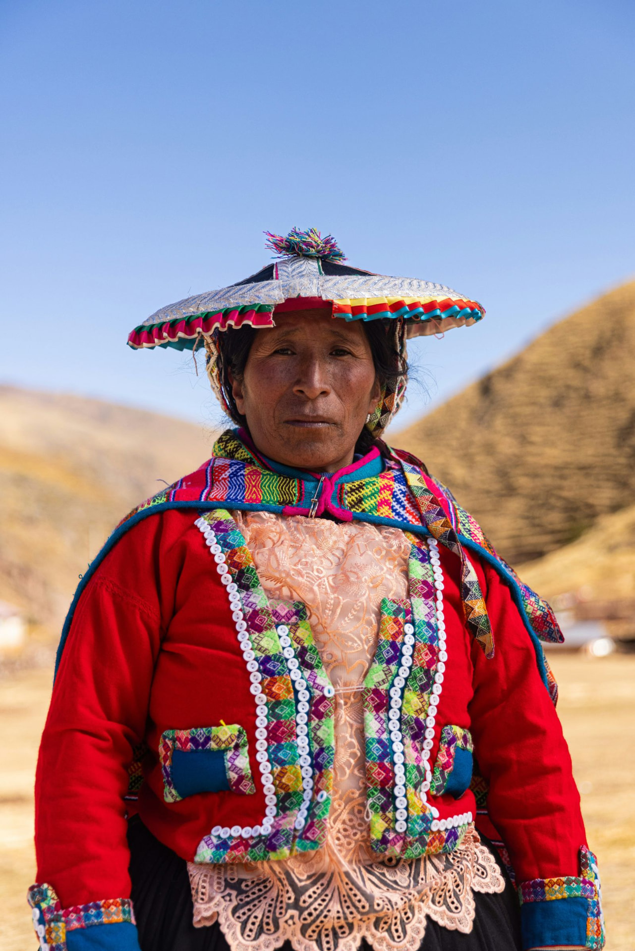 A woman in a traditional hat and embroidered jacket